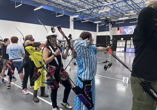 archers taking aim in costume