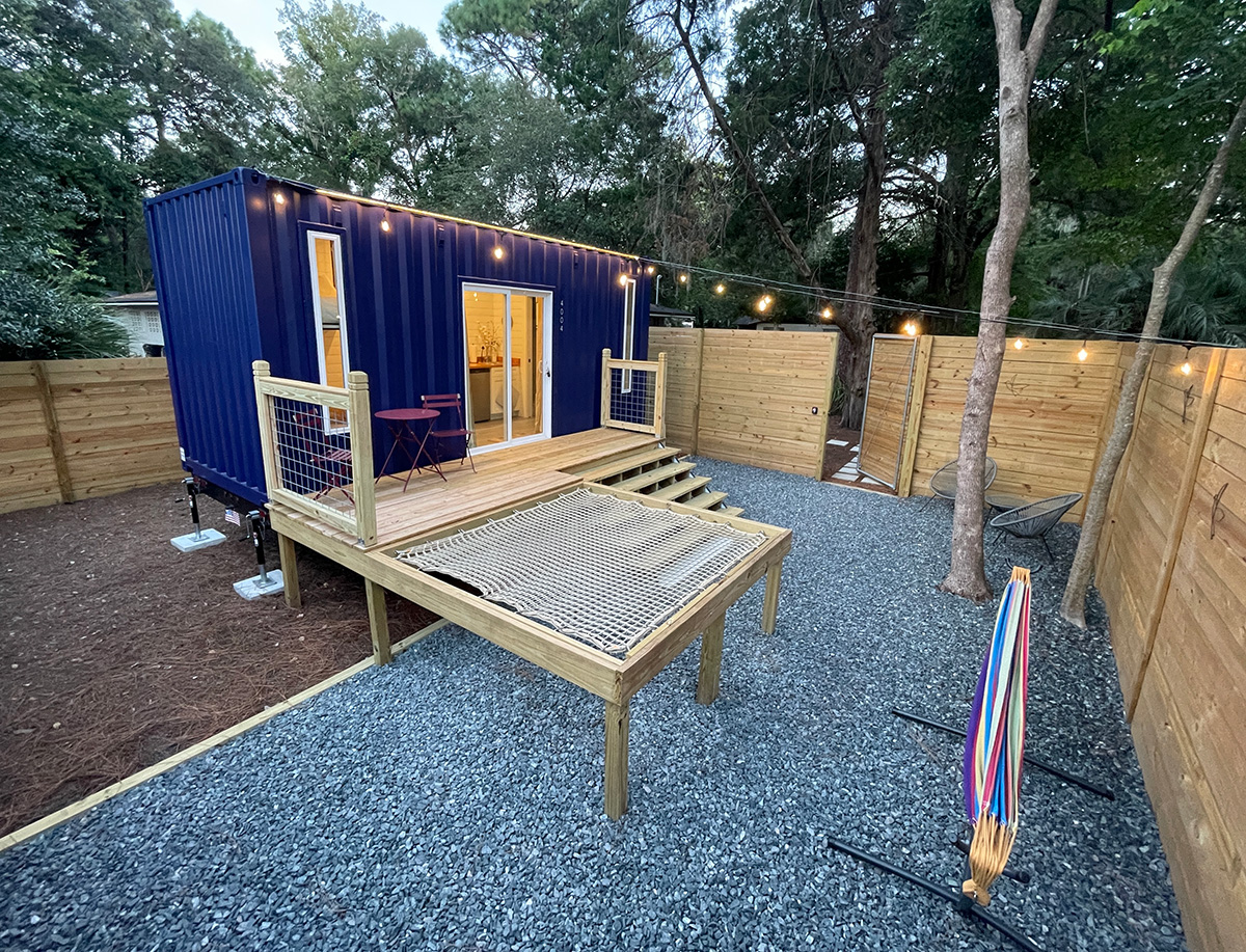 blue container home with string lights