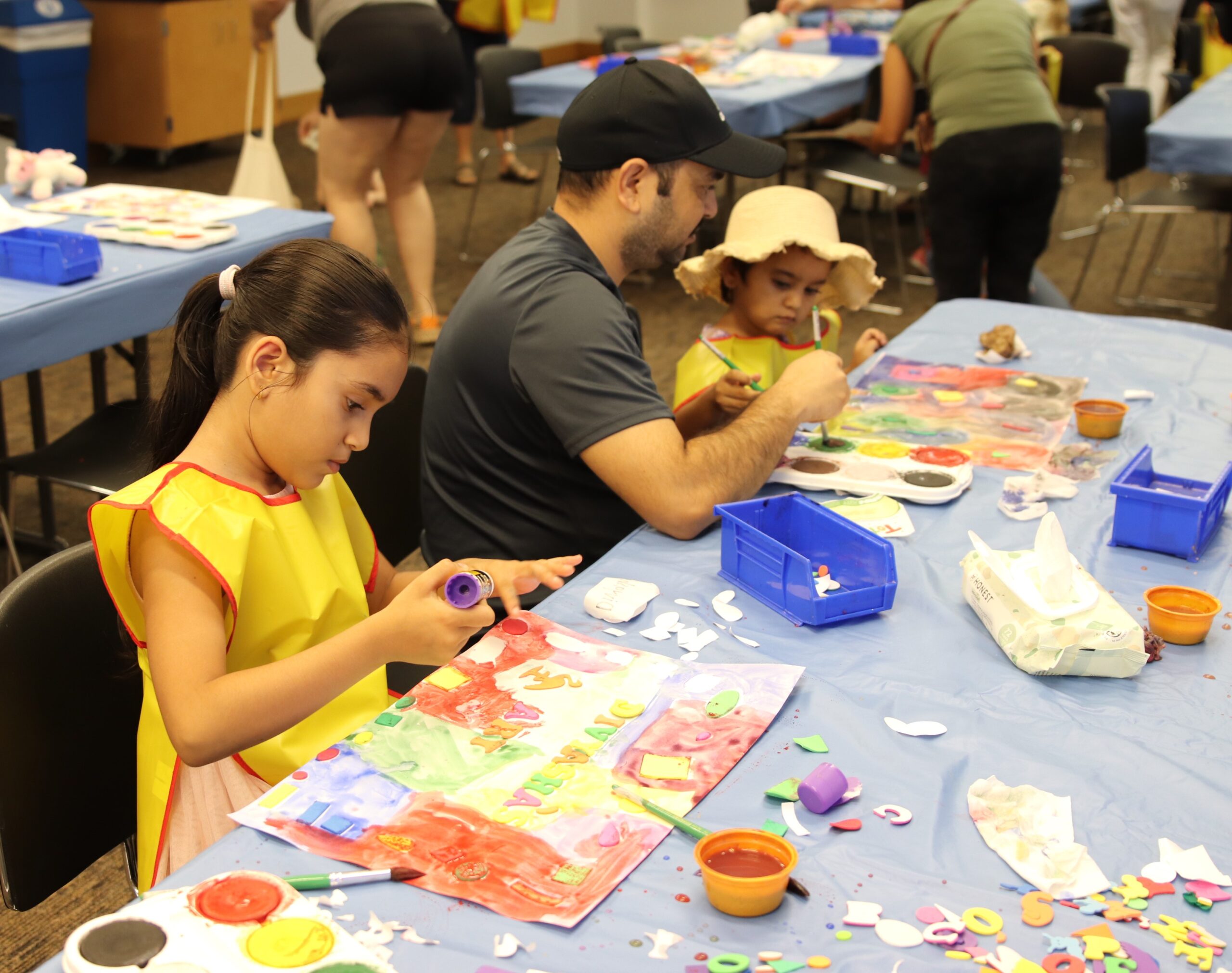 family with kids at table enjoying an activity