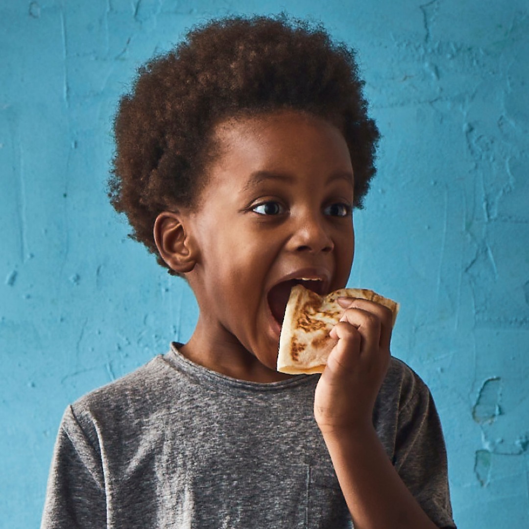 child eating pizza
