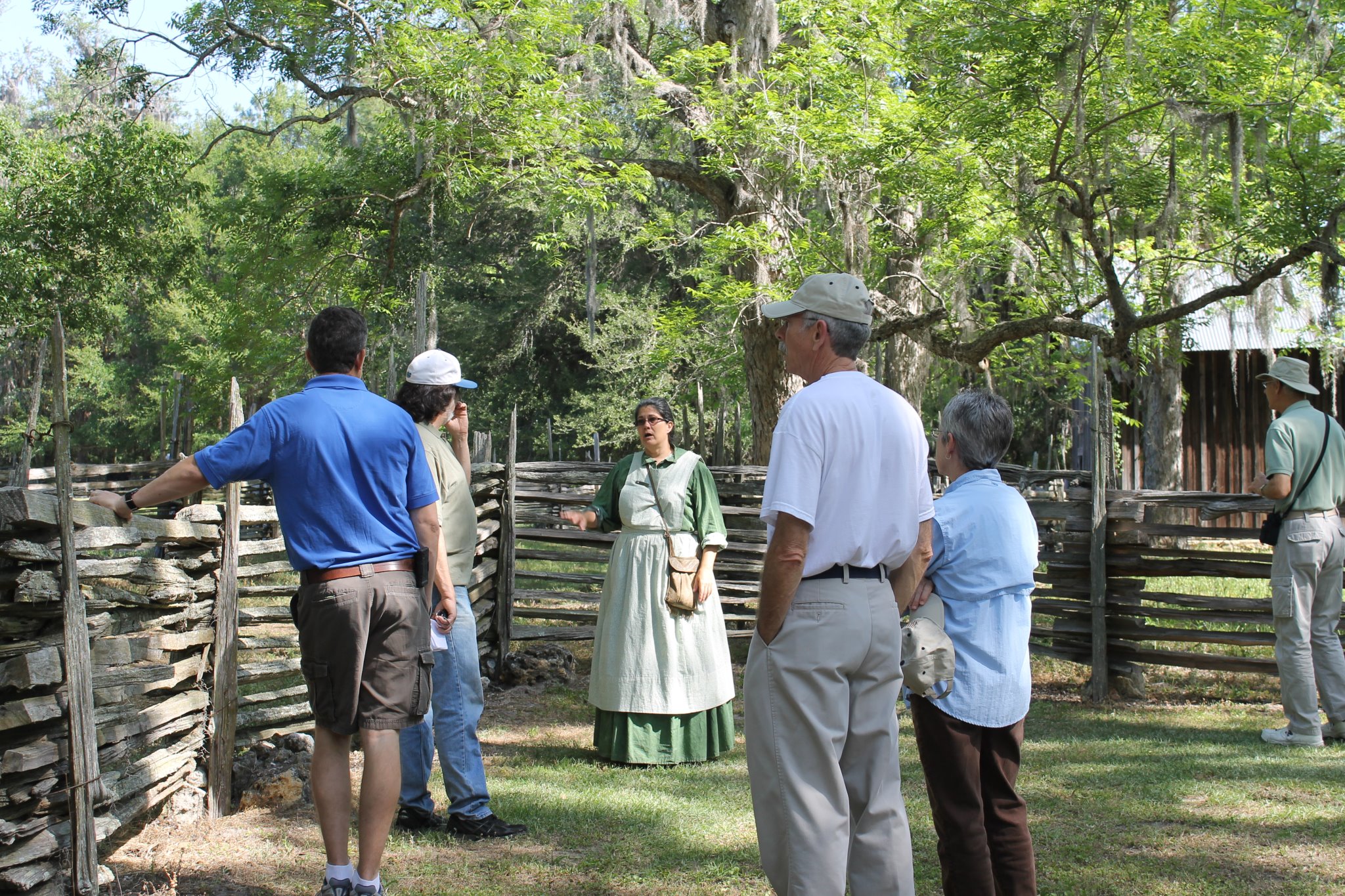 lady in period dress leading a group of visitors