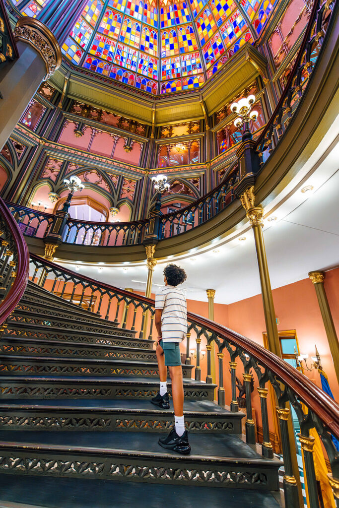 person walking up decorative staircase