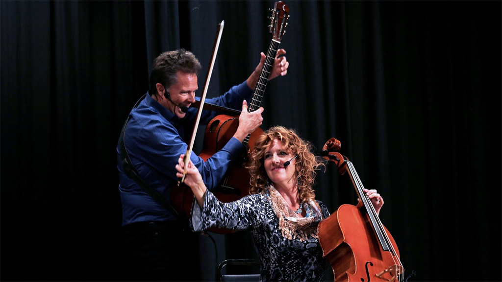 musicians on stage with cello and guitar