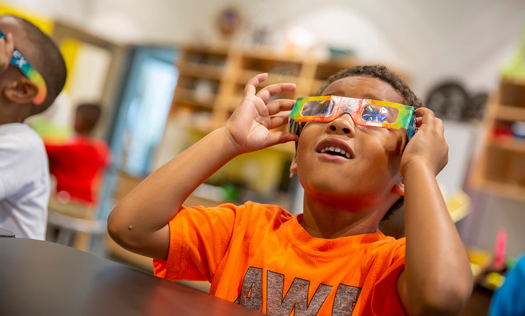 child participating in activity at cade museum with 3-d glasses