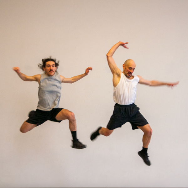 two dancers in mid-air