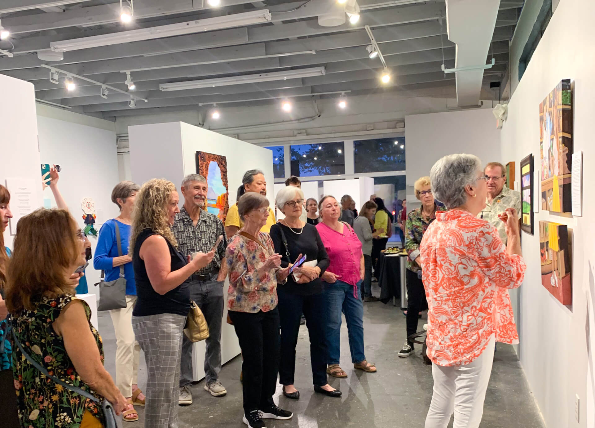 people looking at artwork in art gallery