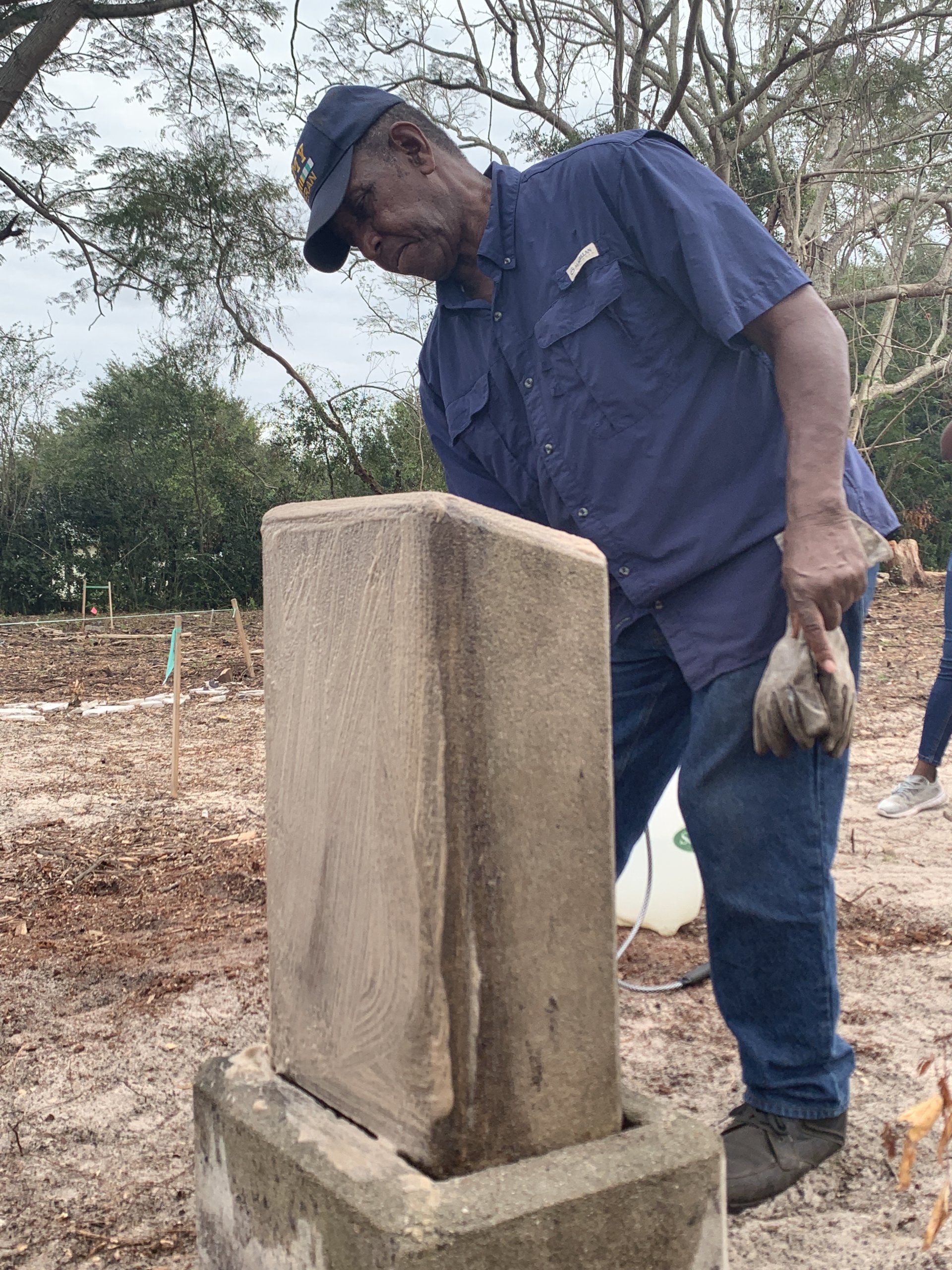 Person ceaning a headstone