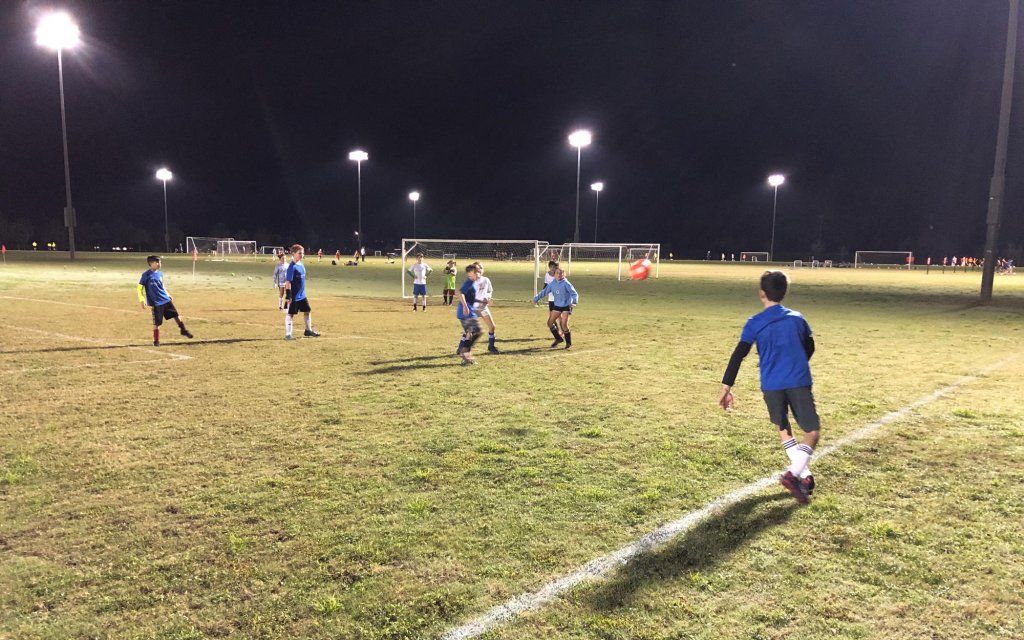 kids playing soccer at night
