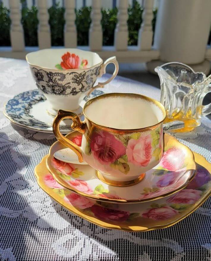 Elegant tea cups and saucers displayed.
