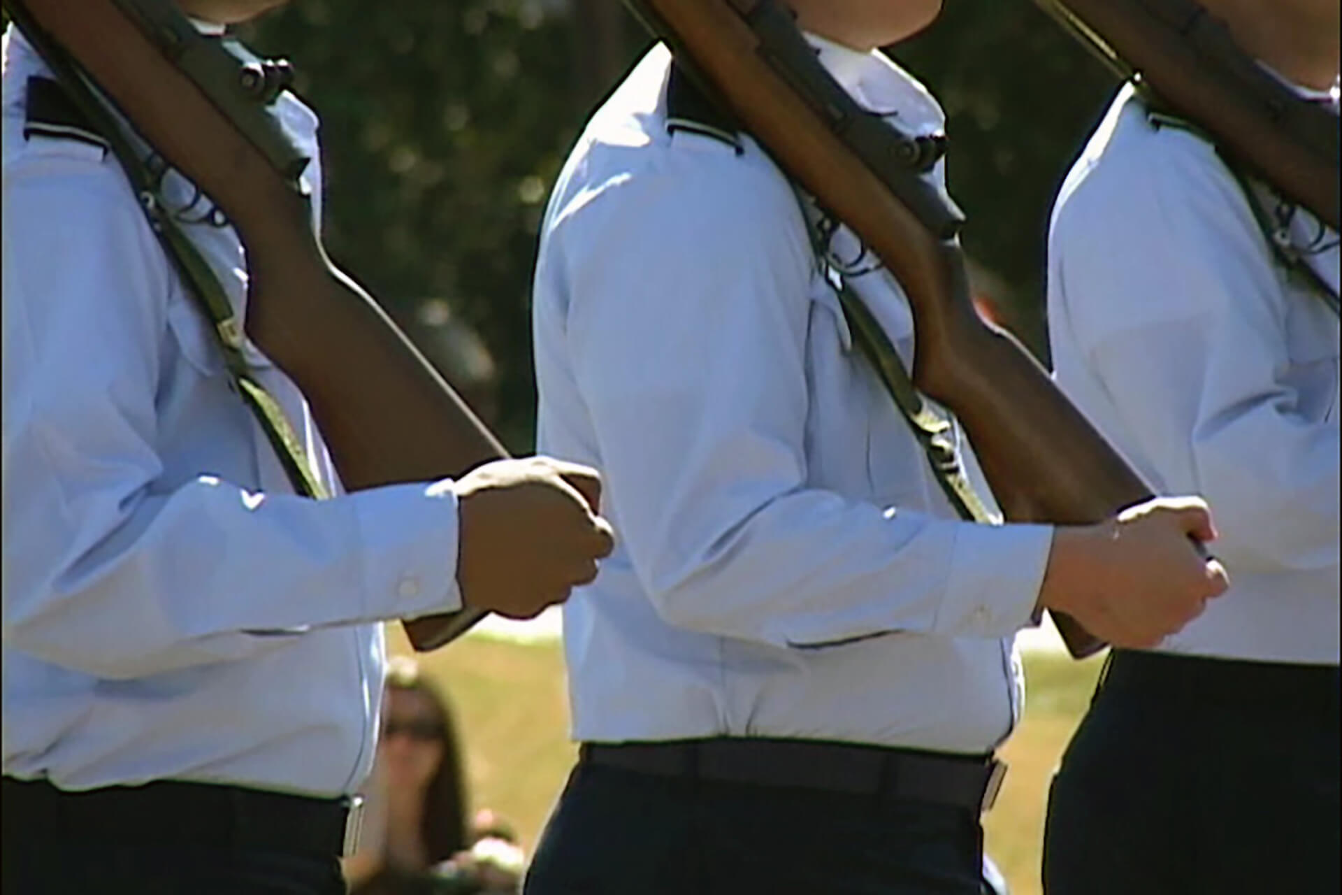 people holding rifles during a memorial day ceremony