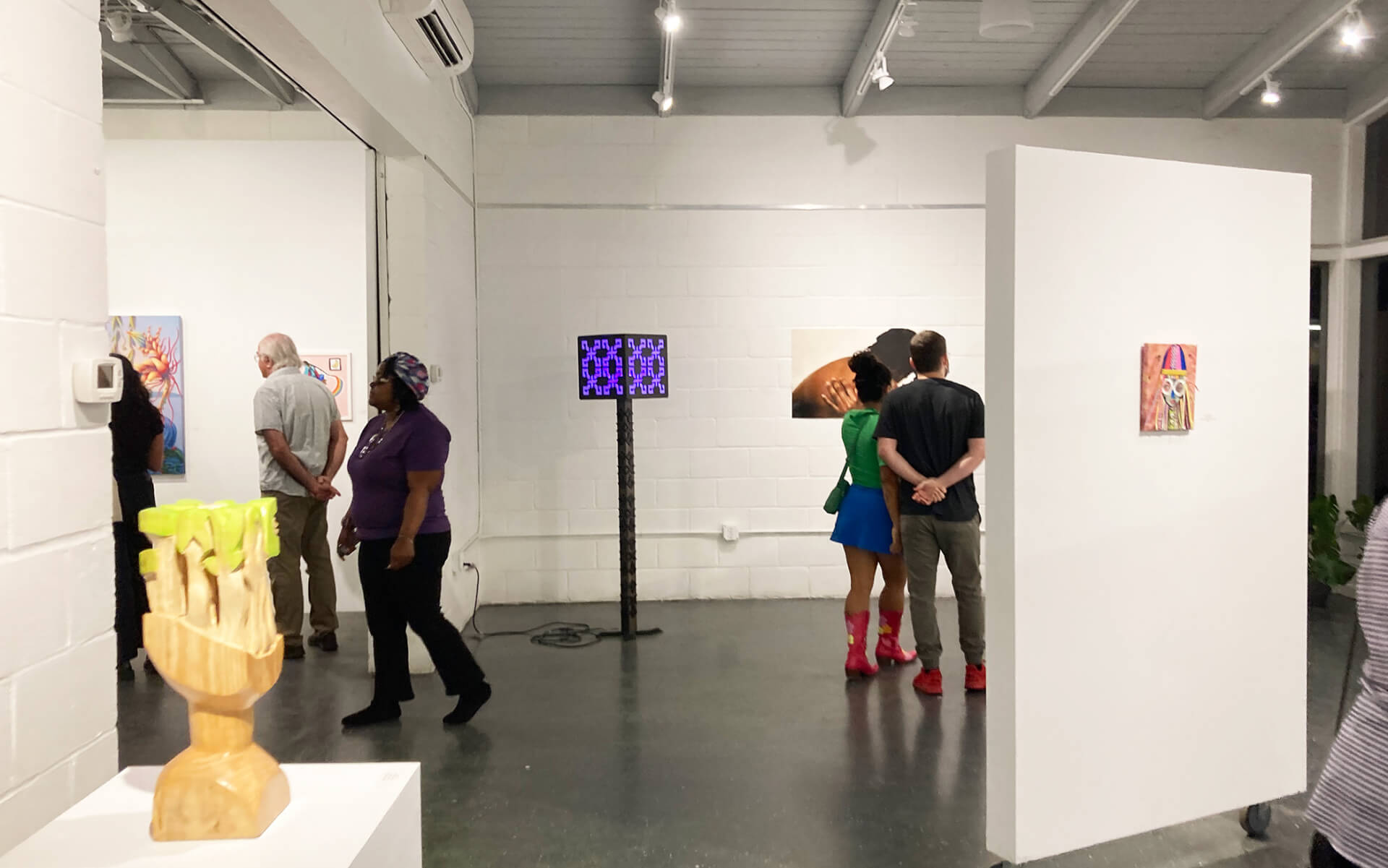 people viewing art at gfaa gallery during artwalk gainesville
