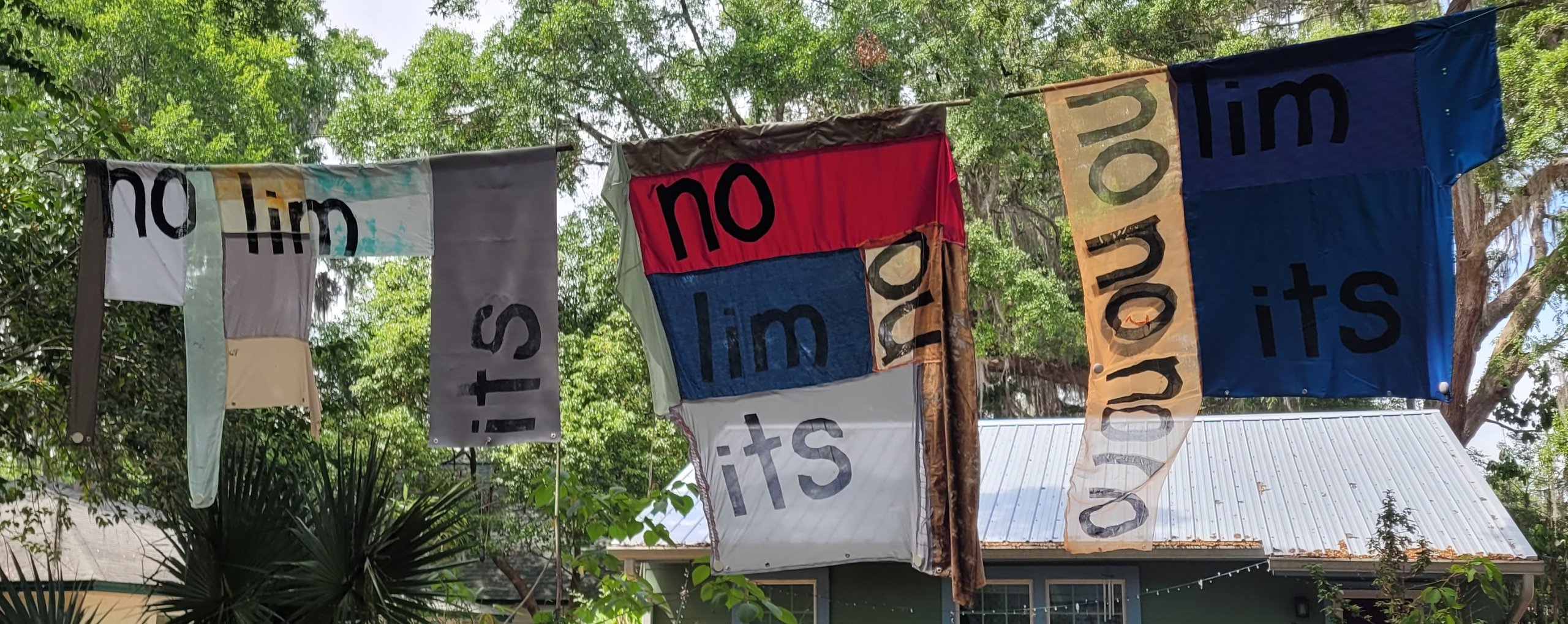 upcycled fabric flags with the text No Limits spread across the various sections of the patchwork textiles