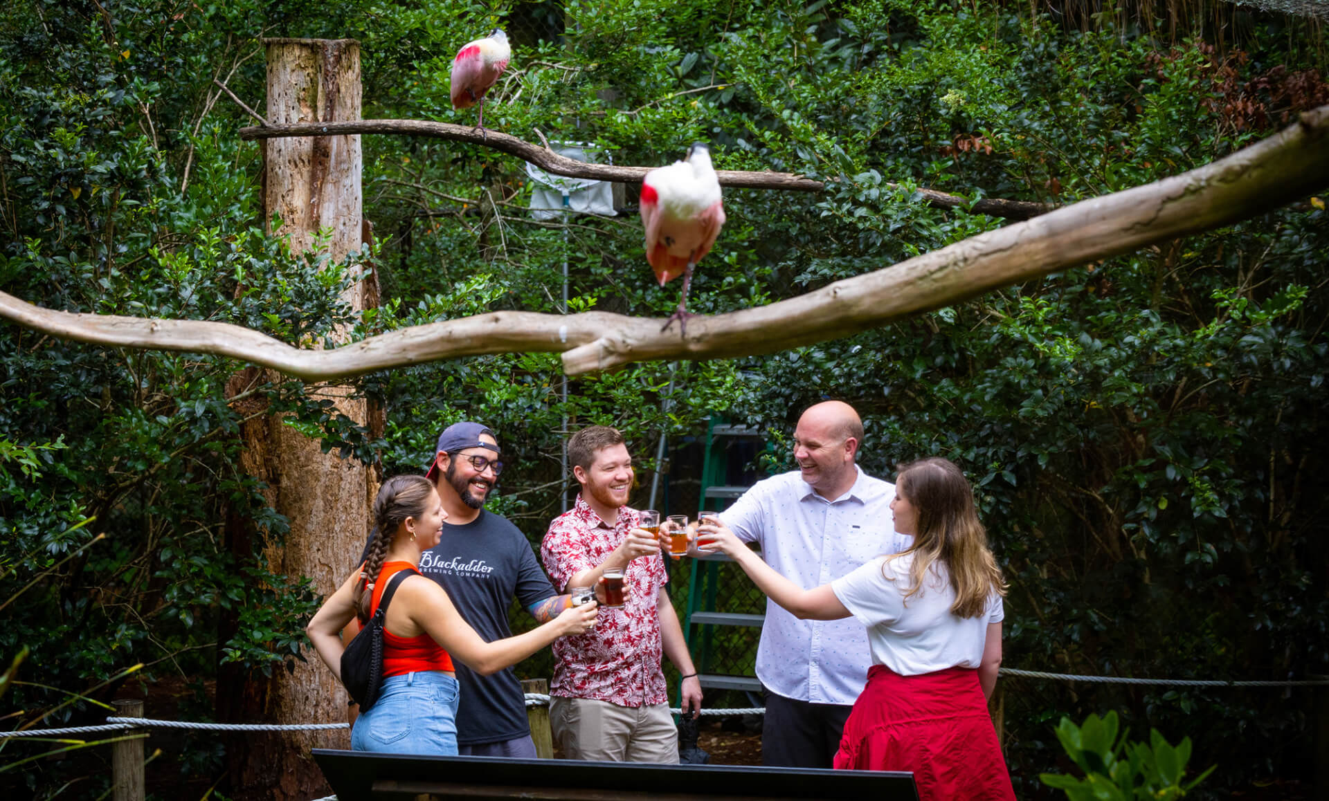 People holding special event sample cups at the zoo
