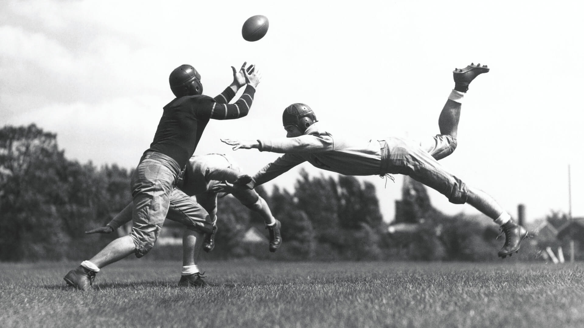 cade museum sports science exhibit - black and white photo of football players