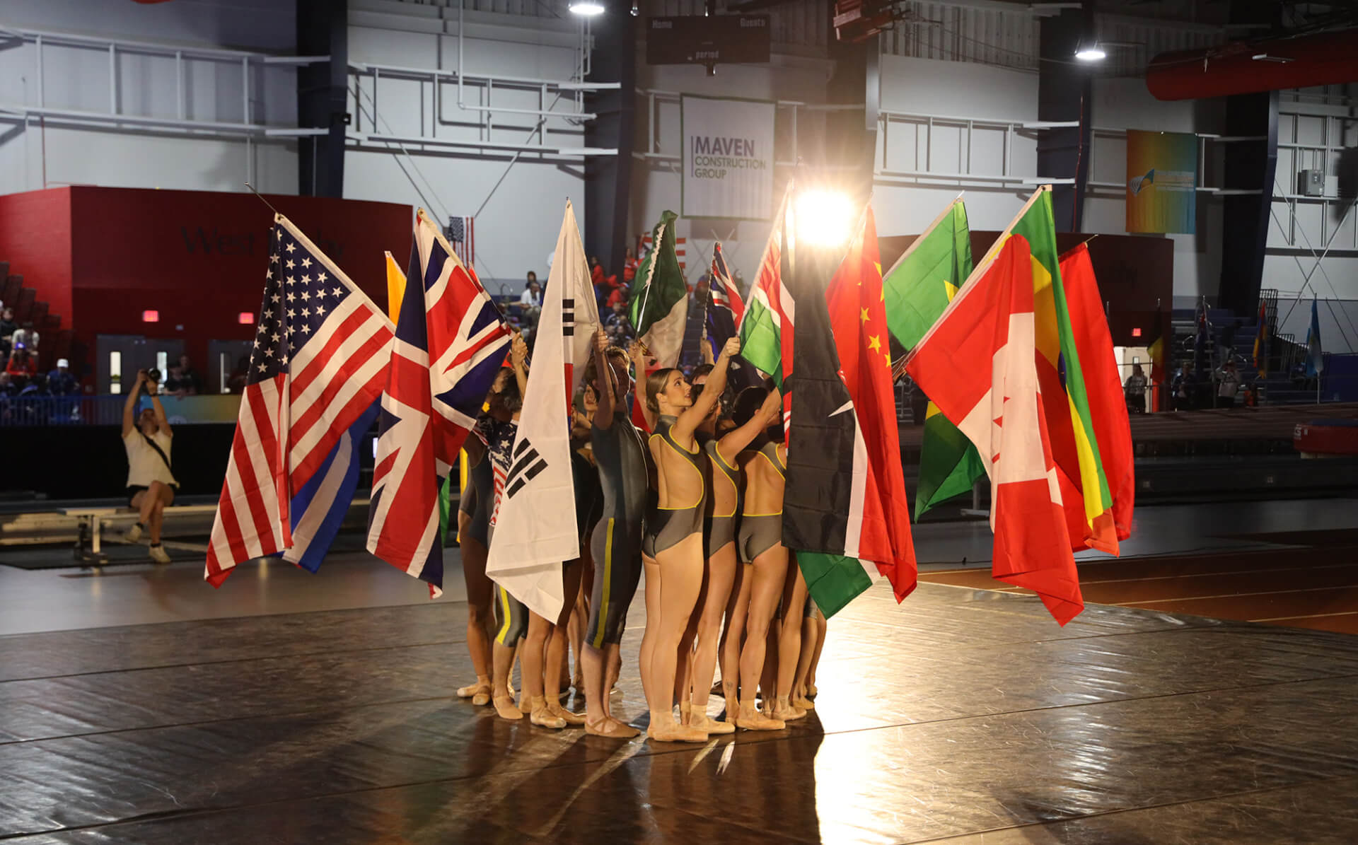 ballet dancers holding flags of the world during a performance