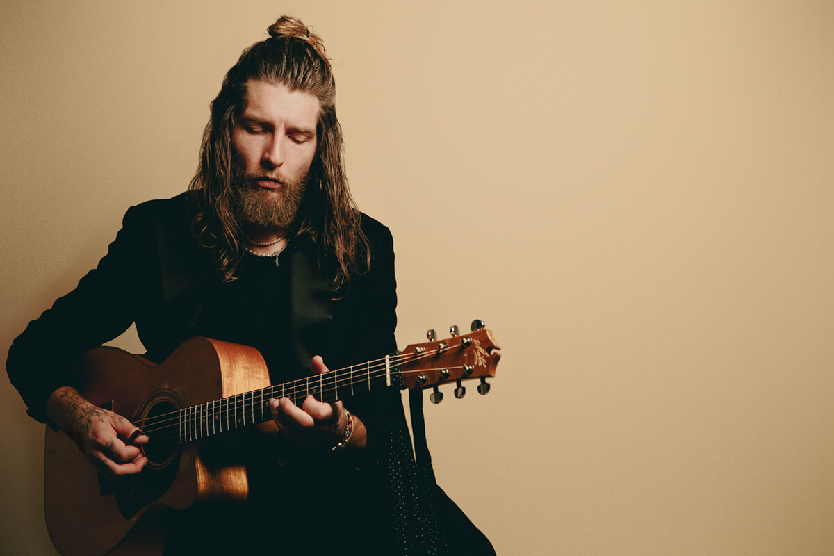 photo of Kieran playing a guitar