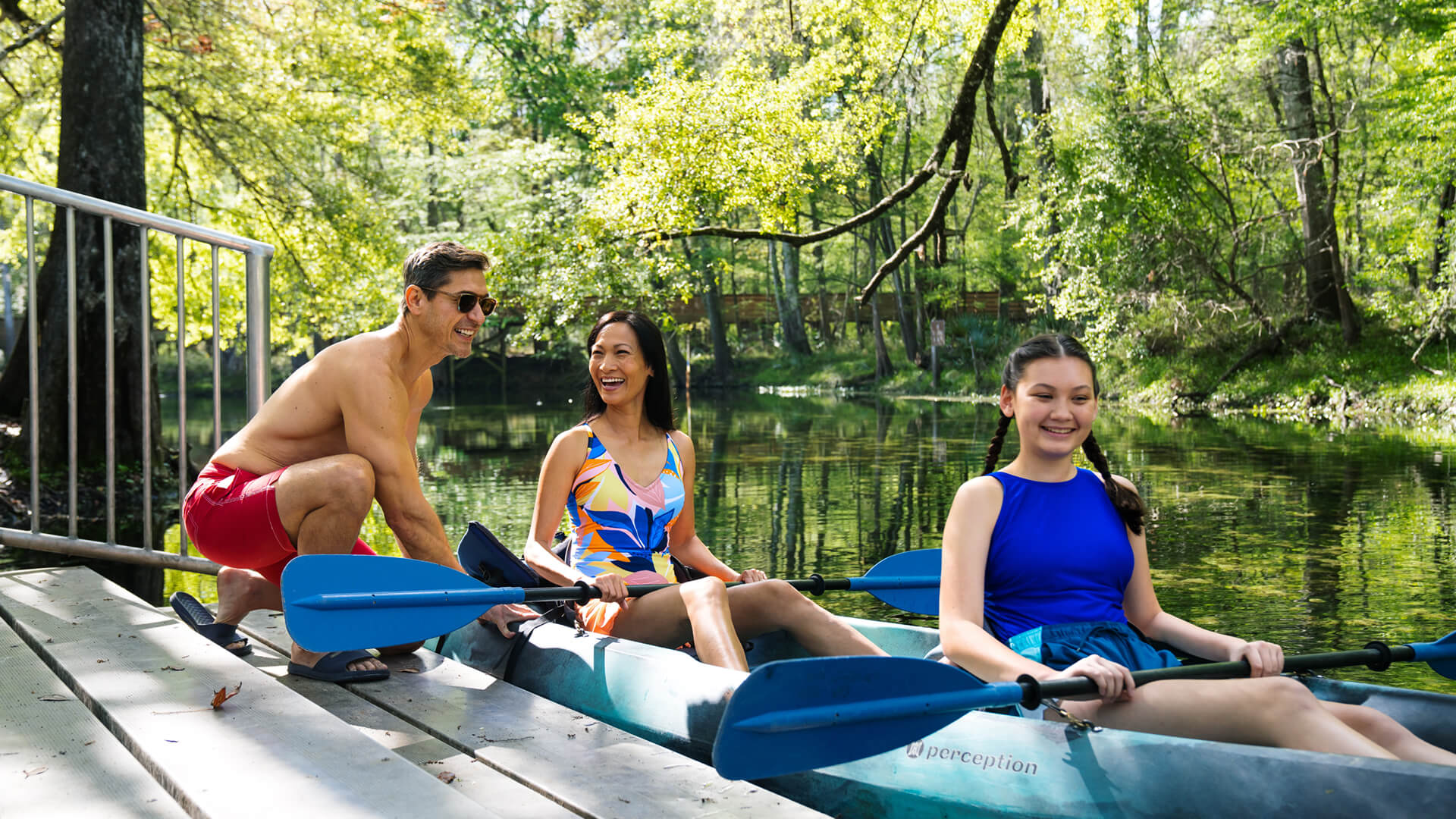 Three people enjoying kayaking together.
